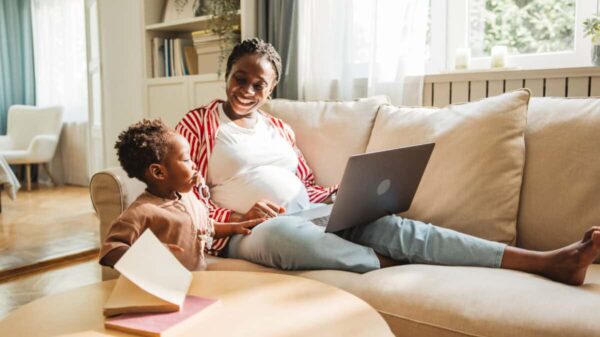 pregnant mother juggles work and childcare