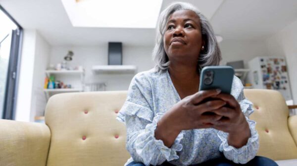 woman looks at iPhone