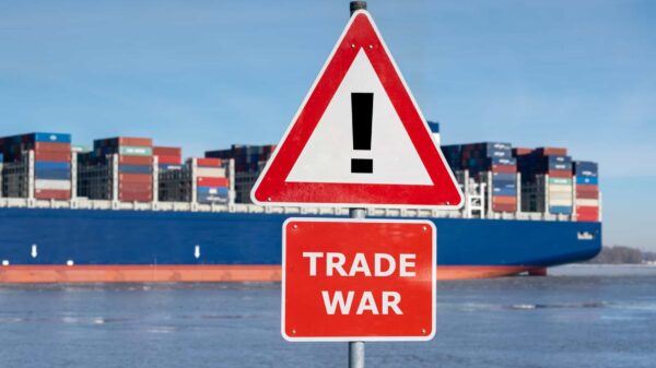Warning sign with the text "Trade war" in front of container ship